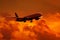 Dark silhouette of aircraft against a red sky