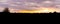 Dark silhouette of a heather forest landscape during the sunset, colorful sky and clouds