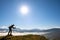 Dark silhouette of a hiker photographer taking picture of morning landscape in autumn mountains