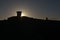 Dark silhouette of malvern hills toposcope and trig point at sunrise