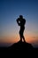 Dark silhouette of a muscular male boxer outdoors on sunset