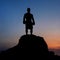 Dark silhouette of a muscular male boxer outdoors on sunset