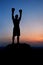 Dark silhouette of a muscular male boxer outdoors on sunset