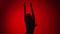 Dark silhouette of playful dancer lady jumping enjoying freedom. Shot with RED camera in 4K