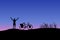 Dark silhouette of touring bike cyclist with bicycle on mountain with sunset background