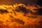 Dark silhouettes of clouds in the orange sky