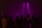 The dark silhouettes of a group of people on the rock concert