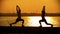 Dark silhouettes of people warming up muscles before the training on the seafront