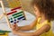 A dark-skinned African-American girl is ready for a math and arithmetic lesson with an abacus