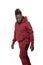 Dark skinned African man with pigtails in a ponytail and beard wearing  burgundy tracksuit walking isolated