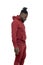 Dark skinned African man with pigtails in a ponytail and beard wearing  burgundy tracksuit walking isolated