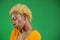 Dark-skinned woman with short bright hairstyle in orange blouse