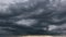 The dark sky with heavy clouds converging and a violent storm before the rain.Bad or moody weather sky and environment. carbon