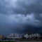 dark sky and heavy rain thunder storm over a city