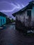 Dark sky with heavy thunderstorms rain hit the village, lighting in the sky