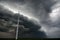 Dark sky and high winds threatening wind turbines