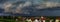 Dark sky, overcast, black clouds. Stormy weather over the village Bergheim. Panoramic view.