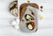 Dark sliced bread, blue cheese, eggs on wooden cutting board decorated with nuts. Flat lay, top view