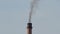 Dark smoke of old factory smokestack.