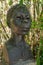 dark stone bust of African black woman. Lisbon botanical garden.