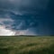 Dark storm clouds gather, ominous atmosphere over landscape