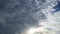 Dark storm clouds and gray cumulus or cirrocumulus cloudscape slowly moved on bright sunrise sky