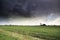 Dark storm clouds over Dutch farmland