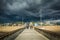 Dark storm clouds over the fishing pier and beach in Venice Beach, Los Angeles, California.