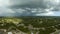 Dark stormy clouds forming on gloomy sky before heavy rainfall over suburban town area