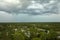 Dark stormy clouds forming on gloomy sky before heavy rainfall over suburban town area