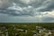 Dark stormy clouds forming on gloomy sky before heavy rainfall over suburban town area