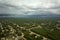 Dark stormy clouds forming on gloomy sky before heavy rainfall over suburban town area