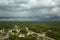 Dark stormy clouds forming on gloomy sky before heavy rainfall over suburban town area