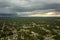 Dark stormy clouds forming on gloomy sky before heavy rainfall over suburban town area