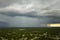 Dark stormy clouds forming on gloomy sky during heavy rainfall season over suburban town area