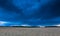 Dark stormy clouds over corn field at summer