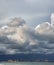 Dark stormy clouds over port cranes and ocean