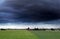Dark stormy sky over summer farmland