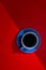 Dark strong coffee in blue cup on red background.