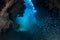 Dark, Submerged Cavern and School of Fish in Caribbean