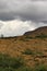 Dark summer clouds loom over an expanse of the stark rocky beauty of the Tablelands ophiolite Gros Morne National Park Canada