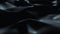 Dark surface with reflections. Smooth minimal black waves background. Blurry silk waves animation loop. Minimal soft