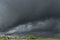 Dark, swirling, threatening clouds in the sky.