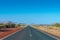 Dark tarmac road in Australian Outback around Cheela Plains Karijini National Park