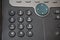 Dark telephone dial buttons of the land-line phone with numbers together with a speed dial above them