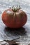 Dark tomato on stone background macro