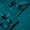 Dark turquoise gift box flat lay composition, greeting card birthday on dark turquoise background. Concept holiday top view