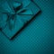 Dark turquoise gift box flat lay on dark turquoise background. Concept present box decoration holiday top view. Copy Space