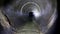 Dark underground sewer round concrete tunnel. Industrial wastewater and urban sewage flowing throw sewer pipe