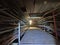 Dark underground tunnel with high-voltage wires laid in iron trays